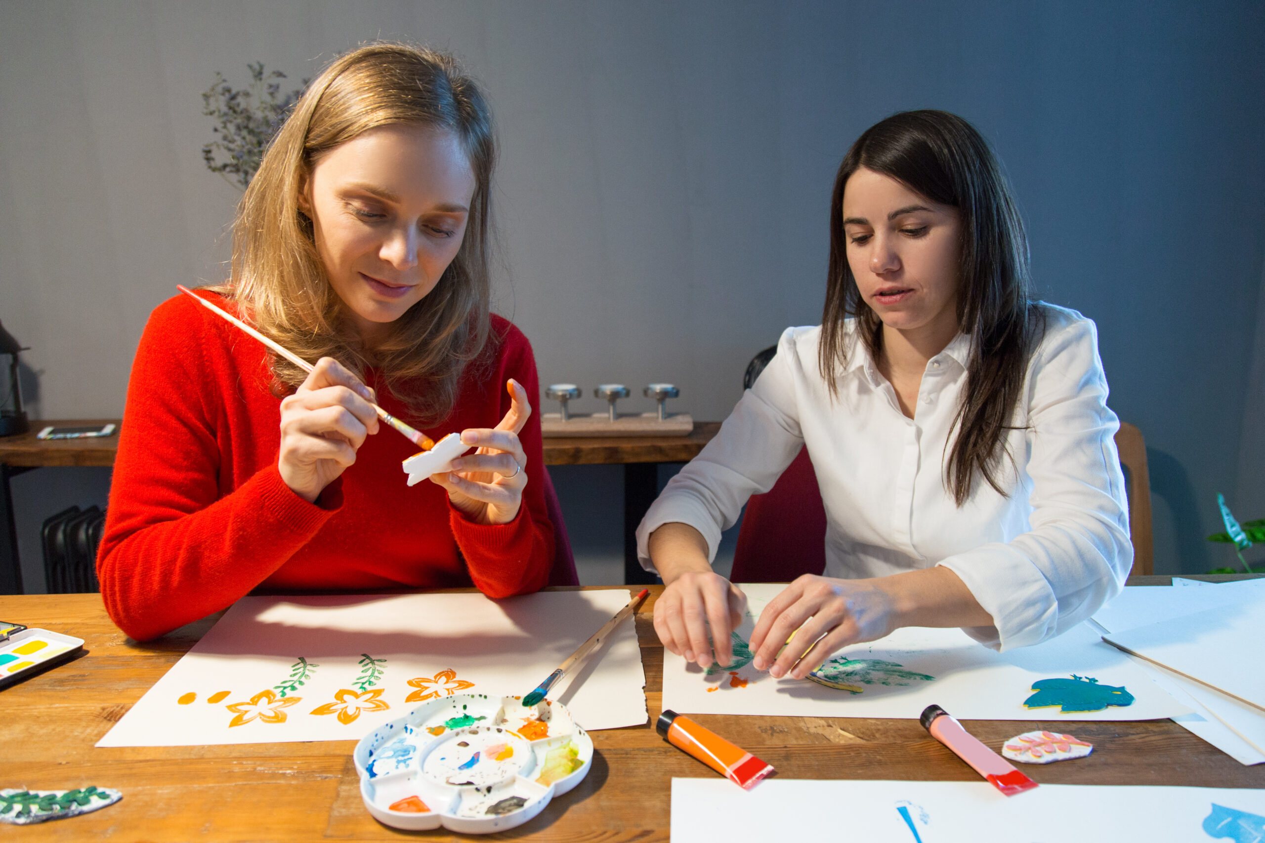 Two peaceful girls enjoying simple painting